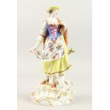 A 20TH CENTURY MEISSEN PORCELAIN FIGURE OF A YOUNG LADY, a lamb at her side. Cross swords mark in
