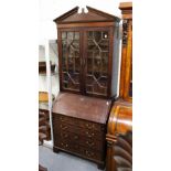 A GEORGE III MAHOGANY BUREAU BOOKCASE, with broken arch pediment, a pair of glazed doors above a