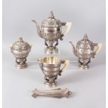 A SUPERB BURMESE SILVER FIVE PIECE TEA SET, with all-over decoration and ivory handles, comprising