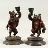 A PAIR OF COLD PAINTED BRONZE CANDLESTICKS, modelled as a fox and a bear. 18cms high.