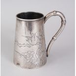 AN EARLY 20TH CENTURY CHINESE SILVER TANKARD by YOK SANG, engraved with almond blossom and birds.