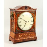 A REGENCY MAHOGANY BRACKET CLOCK, with dome top case, brass ring handles and fretted sides, on bun