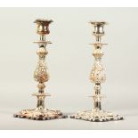 A GOOD PAIR OF PLATED CANDLESTICKS, on square bases. 30cms high.