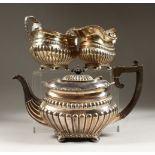 A THREE PIECE EDWARD VIII SEMI FLUTED TEA SERVICE, on ball feet. Chester 1905. Weight 38ozs.