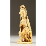 A CARVED IVORY SEATED ORIENTAL FIGURE. 15cms high.