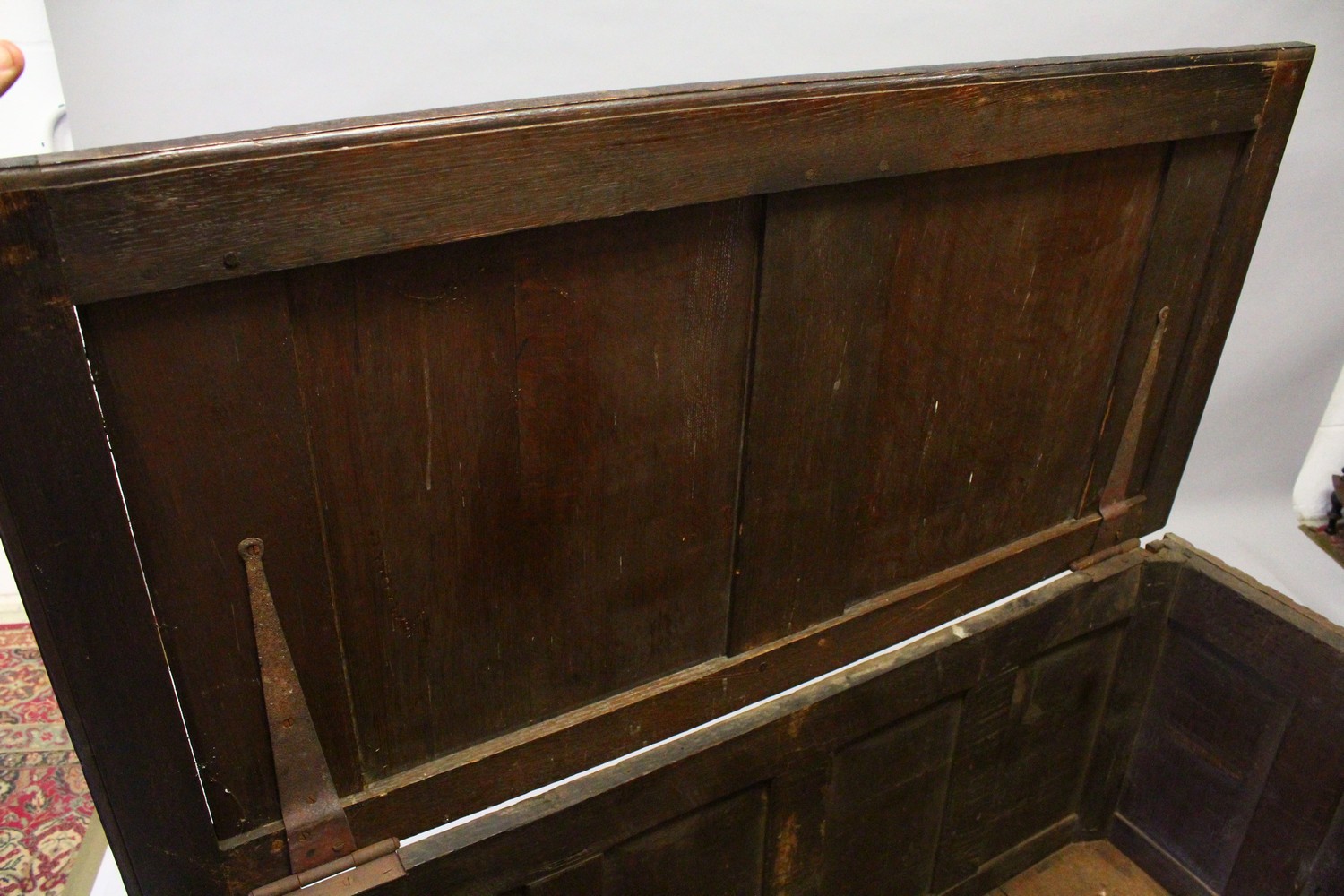 A LARGE 17TH-18TH CENTURY FRENCH OAK COFFER, with two plain panels to the top and two carved - Image 10 of 13