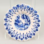 AN 18TH CENTURY DELFT BLUE AND WHITE CIRCULAR SHAPED PLATE, with Chinese design. 25cms diameter.