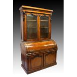 A GOOD VICTORIAN MAHOGANY CYLINDER BUREAU BOOKCASE, the top with double panel glass doors, on a