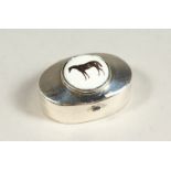 A SILVER AND ENAMEL HORSE PILL BOX.