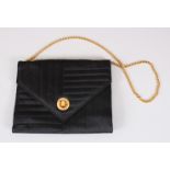 A CHANEL BLACK EVENING BAG, with gilt chain handle.