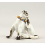 A SMALL MEISSEN PORCELAIN SEATED PUG DOG. Cross swords mark in blue. 6cms high.