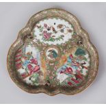A GOOD CANTON CHINESE CIRCULAR CLOVERLEAF SHAPED DISH, painted with three panels of figures,