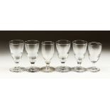 A SET OF SIX PLAIN WINE GLASSES.