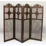 A LARGE BERGERE OAK FOUR FOLD SCREEN, the top carved with cupids and scrolls. 244cms wide overall