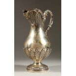 A VICTORIAN IRISH SILVER CLARET JUG, with cast scrolled handle, with shell and acanthus mounts.