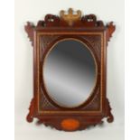 A MAHOGANY SHELL INLAID MIRROR, with oval mirrored panel. 83cms long.