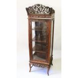 A VERY GOOD CHINESE REDWOOD STANDING CHINA DISPLAY CABINET, the top with a pierced frieze, over a