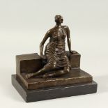 IN THE MANNER OF HENRY MOORE A bronze of a lady sitting on a bench. 24cms wide x 24cms high.