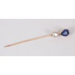 A DIAMOND AND SAPPHIRE STICK PIN.