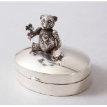 A NOVELTY SILVER PILL BOX, with articulated Teddy.