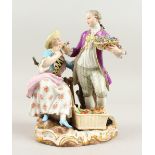 A 19TH CENTURY MEISSEN GROUP, a gallant holding a basket of flowers, giving to a young lady seated