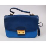 A MIU MIU DARK ROYAL LEATHER BAG, in a light blue cloth bag.