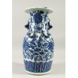 A 19TH CENTURY CHINESE BLUE & WHITE PORCELAIN VASE, with formal scroll & vine decoration, twin