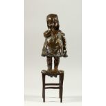 JUAN CLENA A LOVELY BRONZE OF A YOUNG GIRL standing on a stool. Signed. 34cms high.