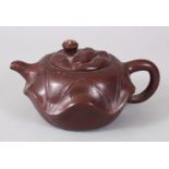 A CHINESE YIXING TERRACOTTA POTTERY TEAPOT AND COVER, with kylin handle.