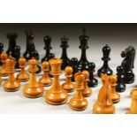 A STAUNTON CARVED WOOD TOURNAMENT SIZE WEIGHTED CHESS SET.
