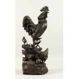 AFTER A. CAIN A LARGE BRONZE ROOSTER, HEN AND CHICKS. Signed A. CAIN. 53cms high.