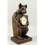 A BLACK FOREST STYLE CARVED WOOD CLOCK, modelled as a bear. 31cms high.