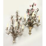 TWO VERY SIMILAR FLORAL WALL SCONCES, with three branches and porcelain flowers. 72cms long.