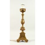 A BRASS PRICKET CANDLESTICK, converted to electricity. 52cms high.