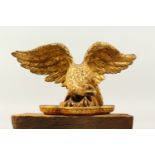 A GEORGIAN CARVED AND GILDED WOOD EAGLE, probably from the top of a mirror. 33cms wide.