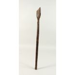A TRIBAL TOOL HANDLE, POSSIBLY MAORI, with circular decoration and metal wire banding. 55.5cms.