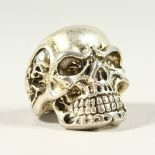 A LARGE SILVER SKULL RING.