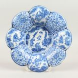 AN 18TH CENTURY DUTCH TIN GLAZE BLUE AND WHITE SHAPED DISH, with Chinese design. 24cms diameter.