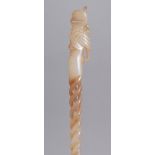 A CARVED AND PIERCED WHITE JADE HAIRPIN. 24cms long.