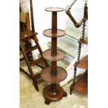 A MAHOGANY CIRCULAR FOUR TIER DUMB WAITER, with reeded column support, on a circular base with