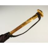 A LADIES PARASOL, with ornate gilt metal handle. 85cms long.