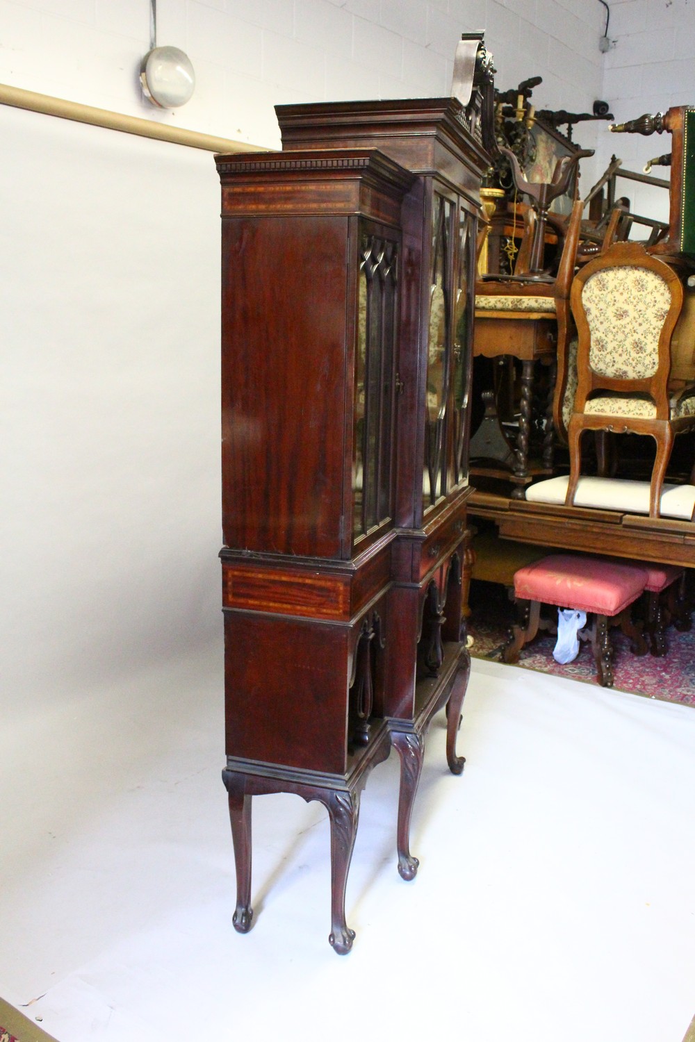 AN EDWARDIAN MAHOGANY BREAKFRONT STANDING BOOKCASE, the top with swan neck pediment, over four glass - Image 8 of 11