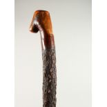 AN IRISH RUSTIC CARVED WALKING STICK. 99cms long.