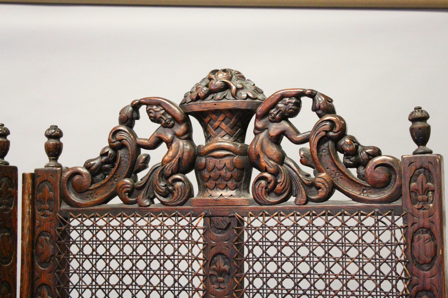 A LARGE BERGERE OAK FOUR FOLD SCREEN, the top carved with cupids and scrolls. 244cms wide overall - Image 4 of 10