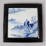 A LATE 18TH-EARLY 19TH CENTURY CHINESE BLUE AND WHITE FRAMED TILE, figures by a river. 25cms