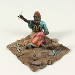 A VIENNA STYLE COLD PAINTED BRONZE OF AN ARAB TAILOR. 12cms long.