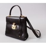 A GUCCI DARK BROWN LEATHER BAG, with small strap handle and long handle, in a Gucci silk bag.