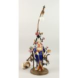 A FRENCH TABLE LAMP, as a Japanese porcelain Geisha, with metal branches and flower head. 34cms