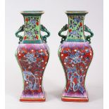 A PAIR OF 18TH CENTURY KANGXI CHINESE BLUE & WHITE CLOBBERED PORCELAIN VASES, decorated in a variety