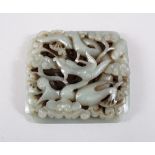 A GOOD CHINESE MING DYNSTY OR LATER CARVED JADE PLAQUE, carved to depict a dragon dog amongst